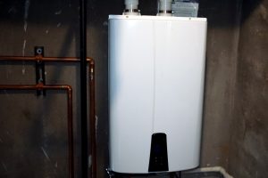 Tankless hot water heater installed in a basement utility room to save money and energy.